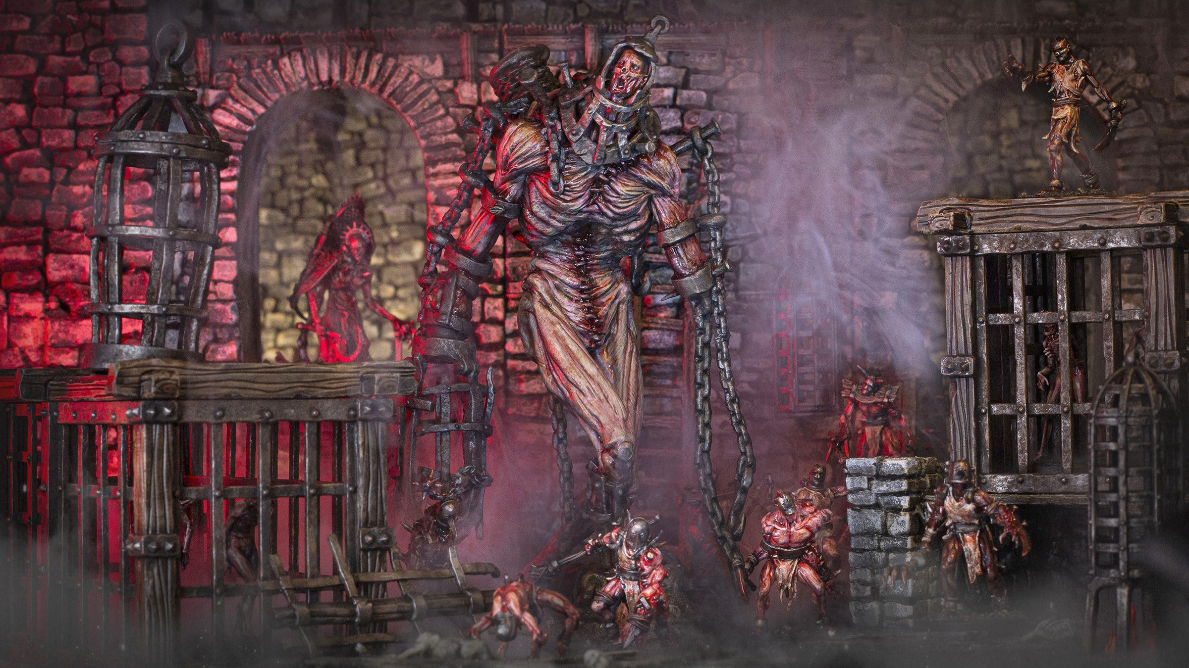 Slave Giant miniature inside a grimdark stone dungeon, surrounded by iron cages, stone columns and atmospheric dungeon terrain.