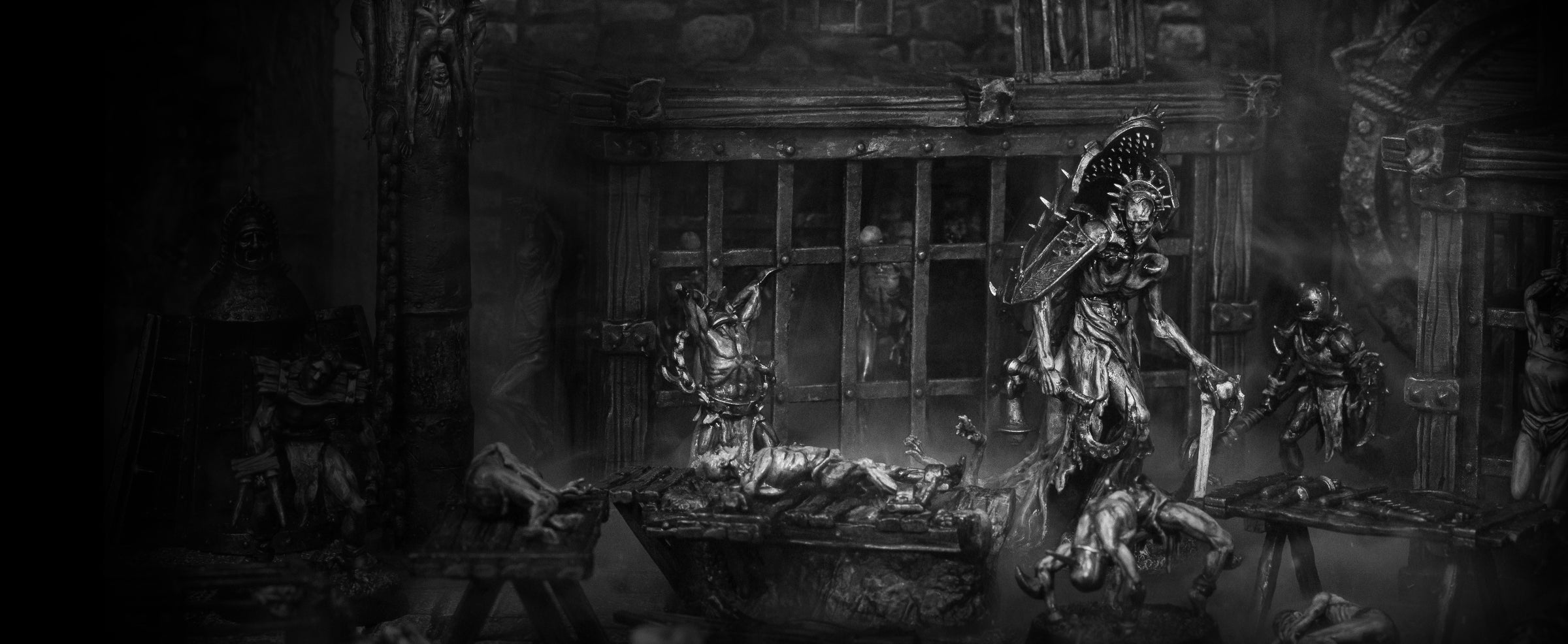 Grimdark dungeon diorama featuring Anatomists miniatures inside a torture chamber with prison cells, surgical tools and stone walls.